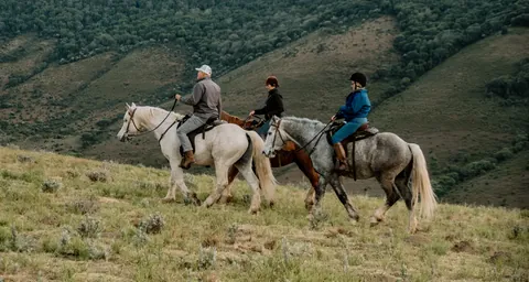 The mounted party crossing a hillside