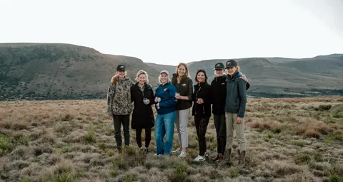A field party gathered in the mountain landscape