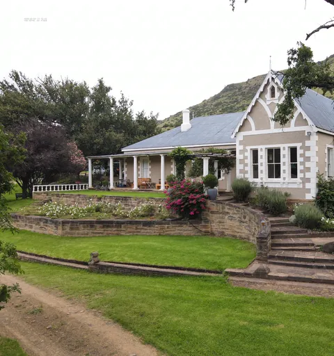 The Whytebank Chase family farmhouse beneath mature trees