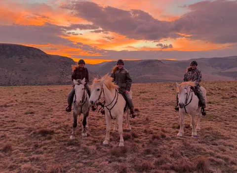 Mounted riders beneath an Eastern Cape sunset